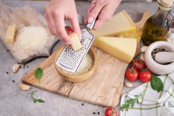 Woman Grates Parmesan Cheese Wooden Cutting Board Domestic Kitchen — ストック写真