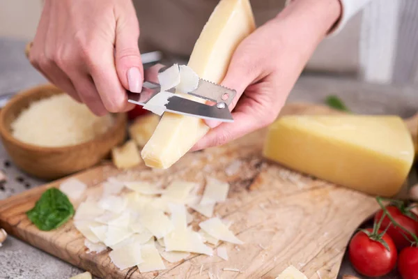 Woman Slicing Parmesan Cheese Wooden Cutting Board Domestic Kitchen — Fotografia de Stock