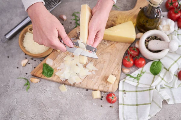 Woman Slicing Parmesan Cheese Wooden Cutting Board Domestic Kitchen — ストック写真