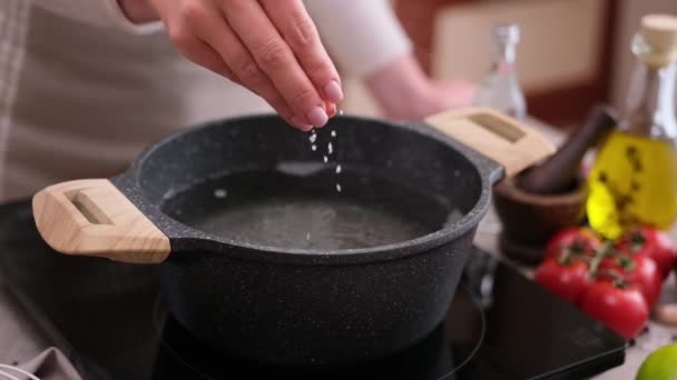 Woman Adding Salt Boiling Water Pot Induction Hob Domestic Kitchen — Wideo stockowe