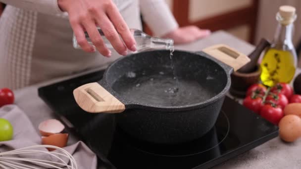 Woman Adding Vinegar Boiling Water Pot Induction Hob Domestic Kitchen — Stockvideo