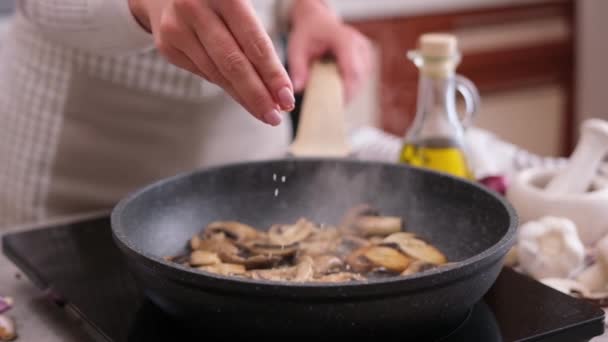 Woman Salting Frying Chopped Champignon Mushrooms Pan — Vídeo de Stock