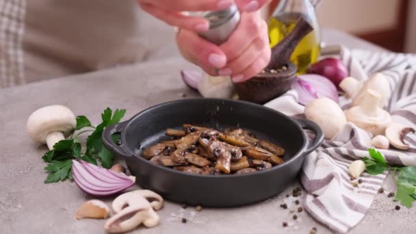 Woman Adding Pepper Fried Champignon Mushrooms Black Ceramic Plate — Video
