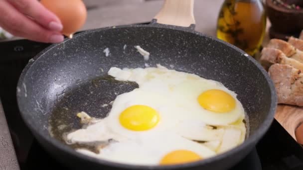 Woman Breaks Egg Hot Frying Pan Stove — Stockvideo