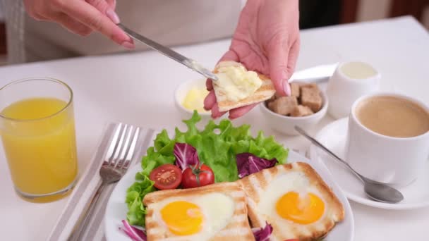 女性がトーストしたパンの上にバターを塗り おいしい卵の入ったトーストの朝食 — ストック動画