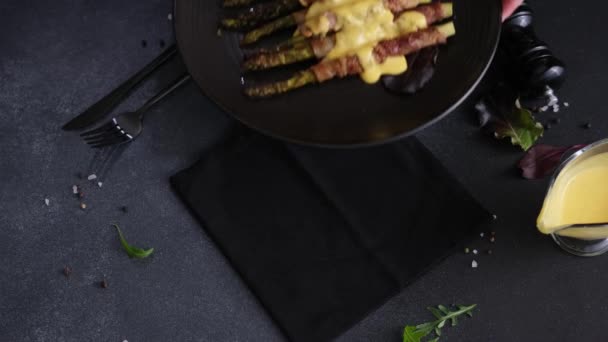 Woman Puts Plate Baked Asparagus Wrapped Bacon Poached Eggs Table — Stock Video