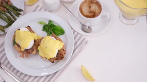 Woman Puts Hollandaise Sauce Glass Gravy Boat Table Egg Benedict — Stock Video