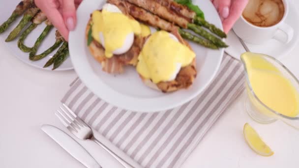 Woman Puts Plate Fried Asparagus Wrapped Bacon Egg Benedict Table — Stock Video