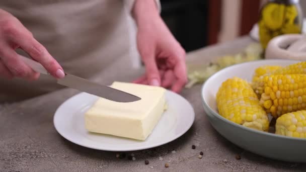 Woman Cuts Piece Butter Freshly Cooked Corn — Stock Video