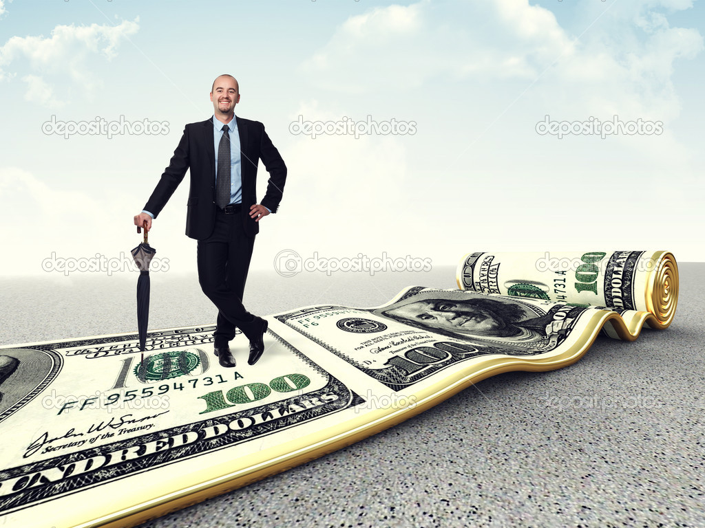 smiling businessman on dollar carpet
