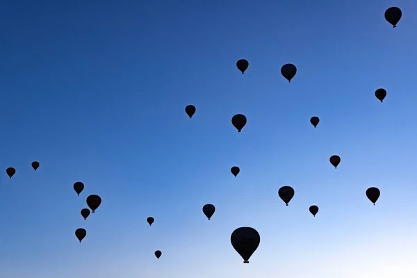 Silhouettes Hot Air Balloons Rising Blue Sky — Stok fotoğraf