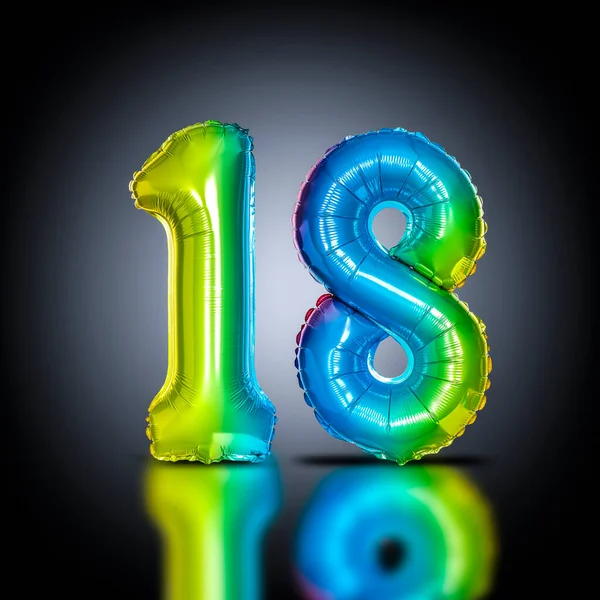 iridescent balloons form the number 18, black background