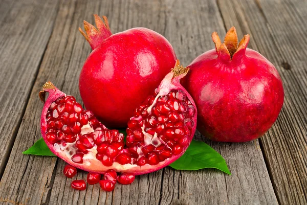 Fresh ripe pomegranates with leave — Stock Photo, Image