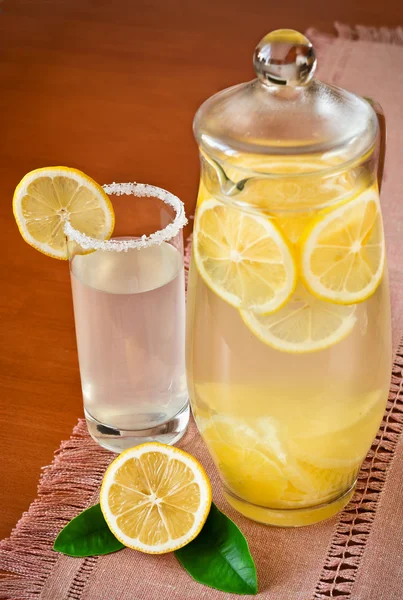 Lemon juice in a jug and fruit — Stock Photo, Image