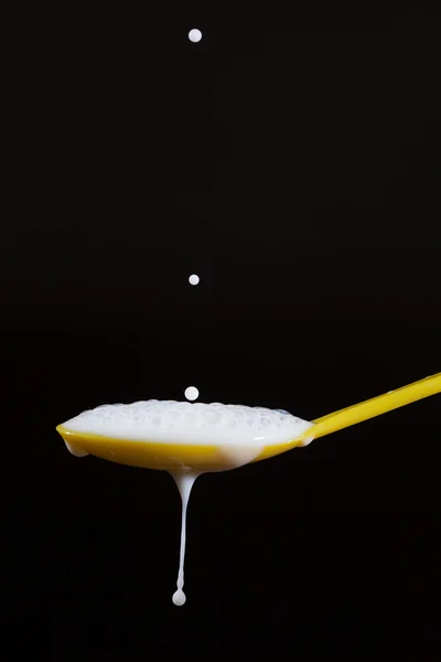 Milk and spoon. — Stock Photo, Image