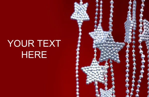 Silver Stars garland on red background — Stock Photo, Image