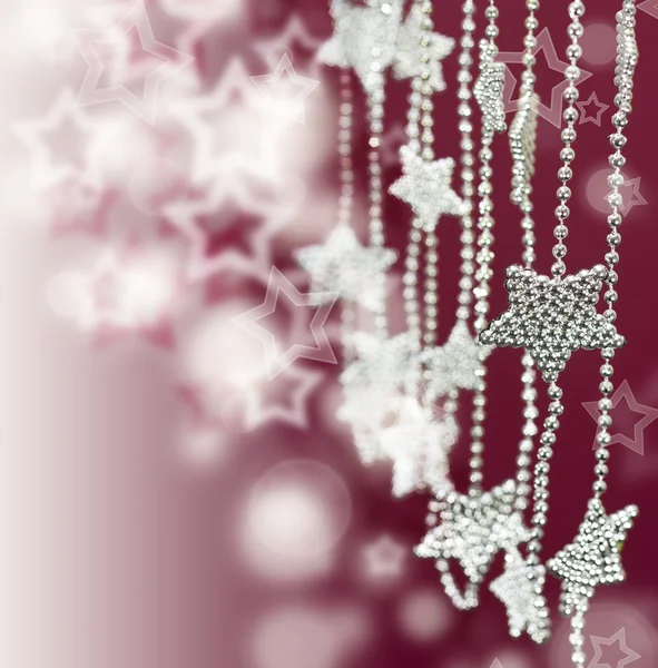 Silver Stars garland on pink blur background — Stock Photo, Image