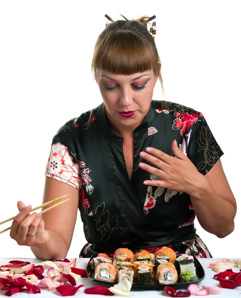 Donna che mangia rotoli — Foto Stock