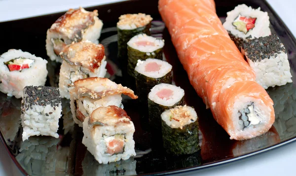 Sushi on black plate — Stock Photo, Image