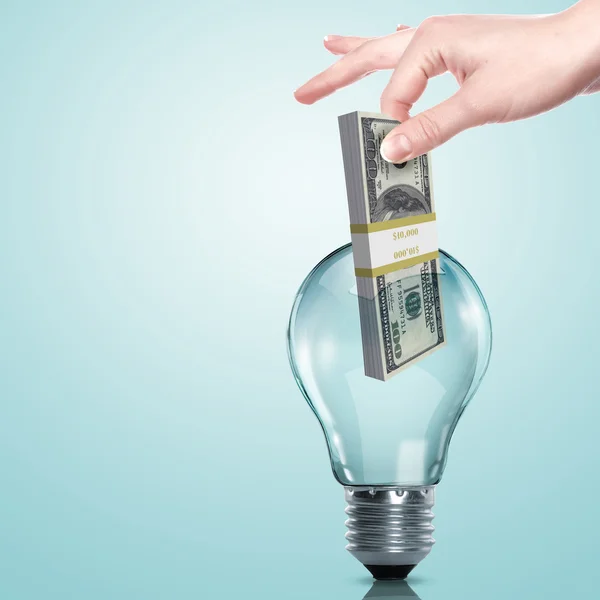 Money inside an electric light bulb — Stock Photo, Image