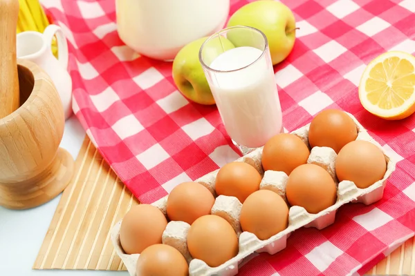 Milk in a glass jar and eggs Stock Image