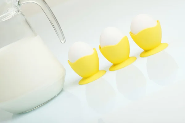 Milk in a glass jar and eggs — Stock Photo, Image