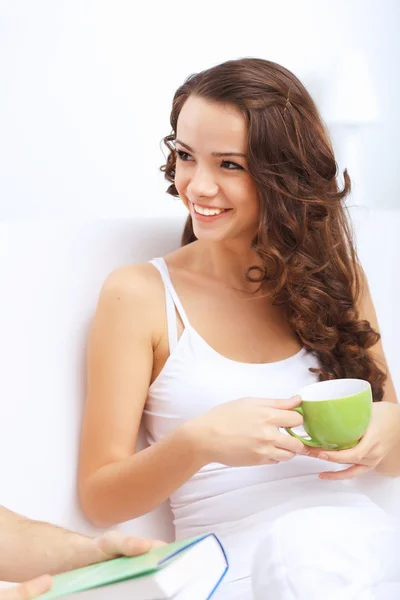 Young pretty woman in white at home — Stock Photo, Image