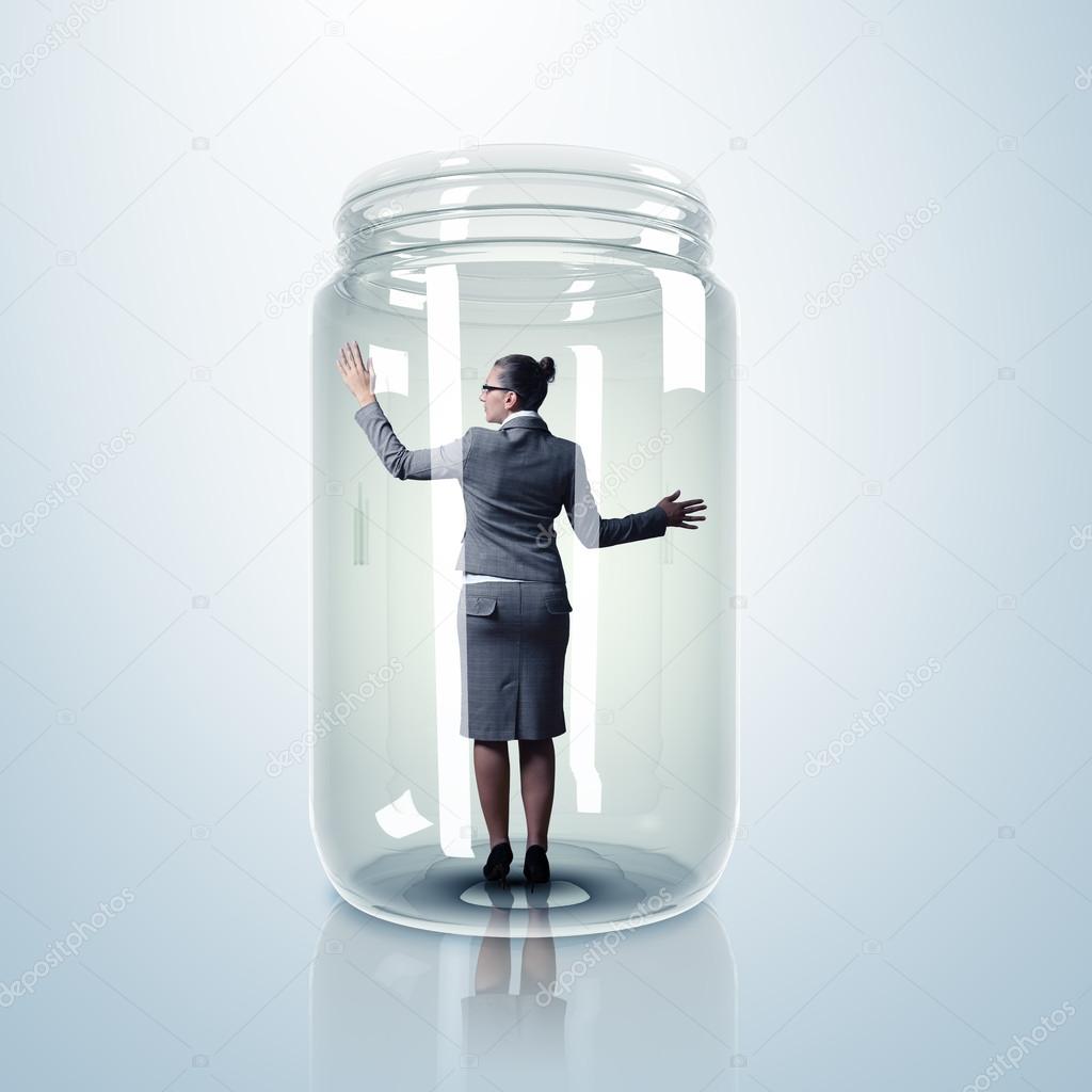 Businesswoman inside glass jar