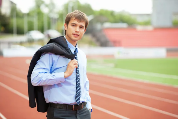 Empresario en estadio atlético y pista de carreras — Foto de Stock