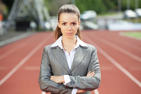 Business woman at athletic stadium — Stock Photo, Image