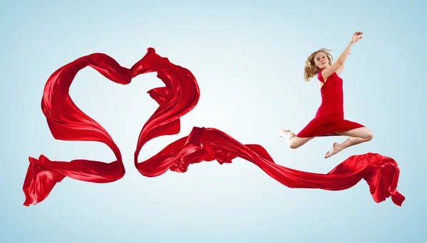 Dancing young woman with flying fabric — Stock Photo, Image