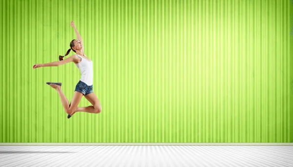 Young woman dancing and jumping... — Stock Photo, Image