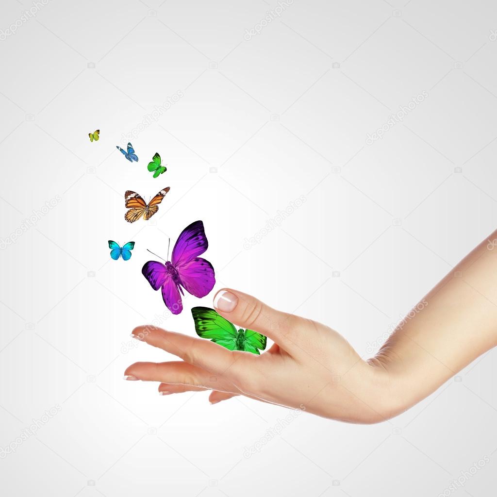 Hands releasing butterflies