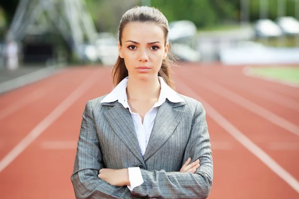 Business woman at athletic stadium — Stock Photo, Image