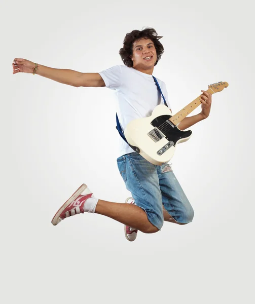 Jovem tocando guitarra electro e pulando — Fotografia de Stock