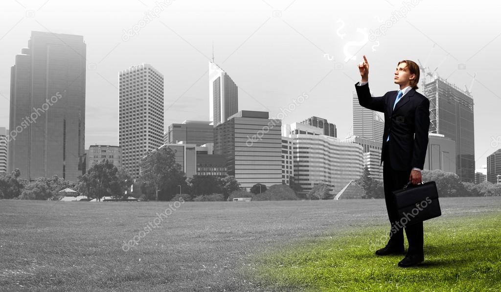 Businessman with colourful light beam in his hands
