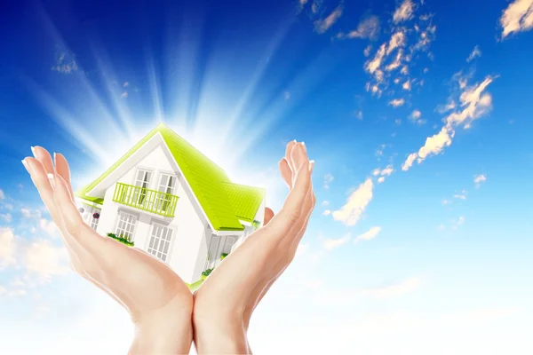 The house in hands on blue sky — Stock Photo, Image