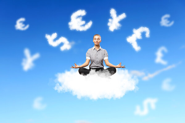 Businesswoman meditating sitting on the cloud