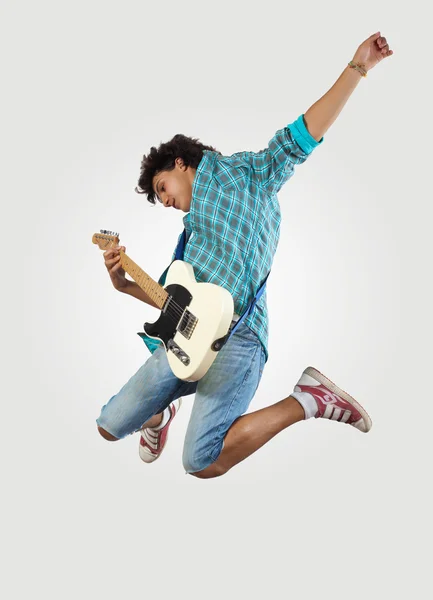 Jovem tocando guitarra electro e pulando — Fotografia de Stock