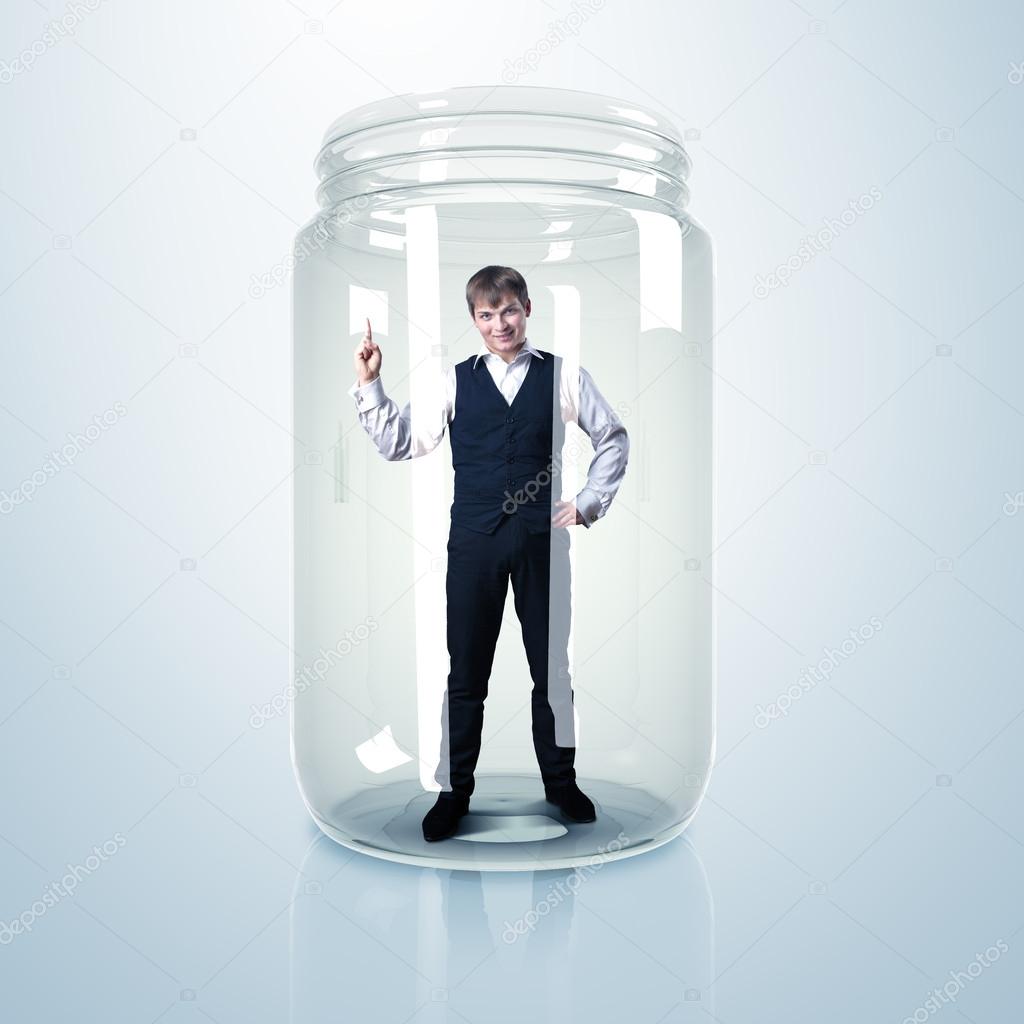 Businessman inside glass jar