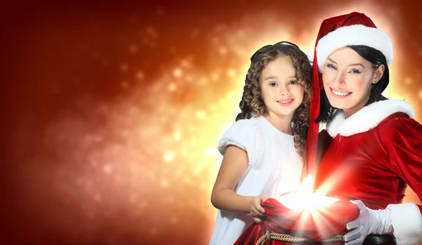 Menina com presentes de Natal e Papai Noel — Fotografia de Stock