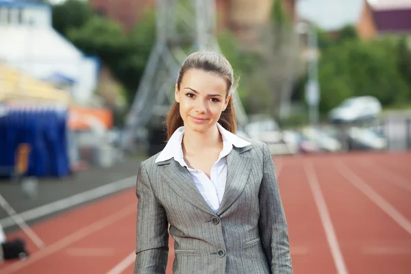 Business woman at athletic stadium