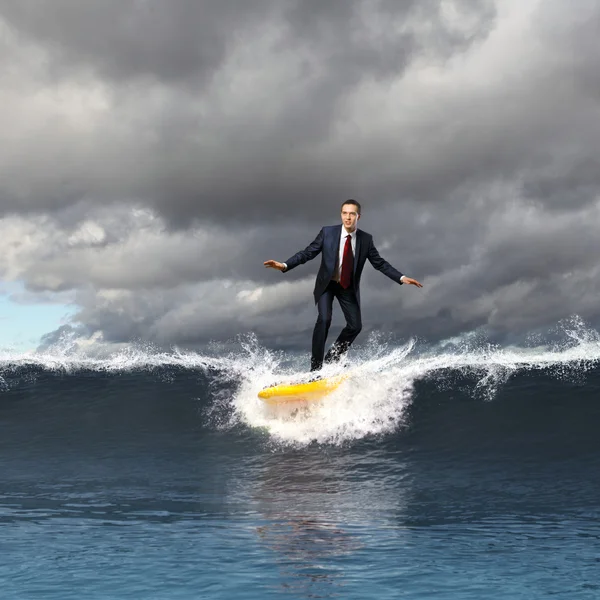 Young business person surfing on the waves