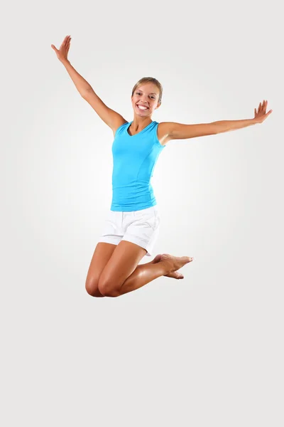 Fitness woman jumping excited Stock Image