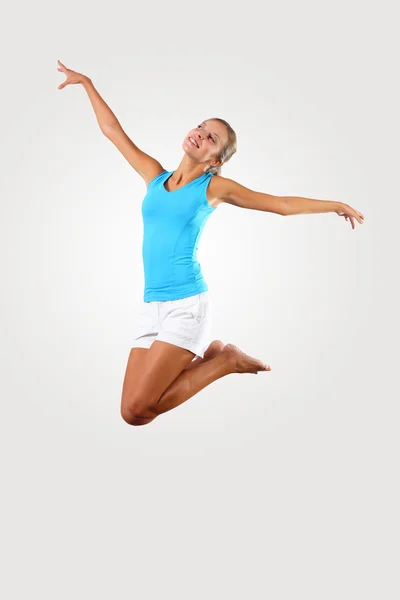 Fitness woman jumping excited Stock Image