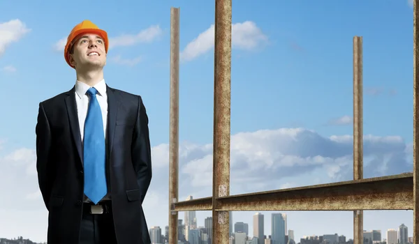 Businessman standing in suit on the construction site — Stock Photo, Image