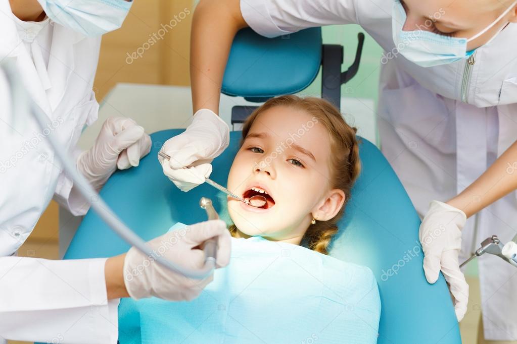 Little girl sitting in the dentists office