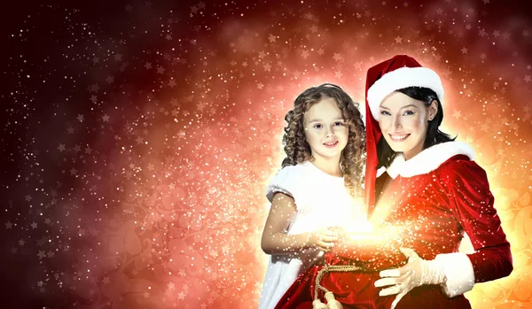 Liten flicka med julklappar och santa — Stockfoto