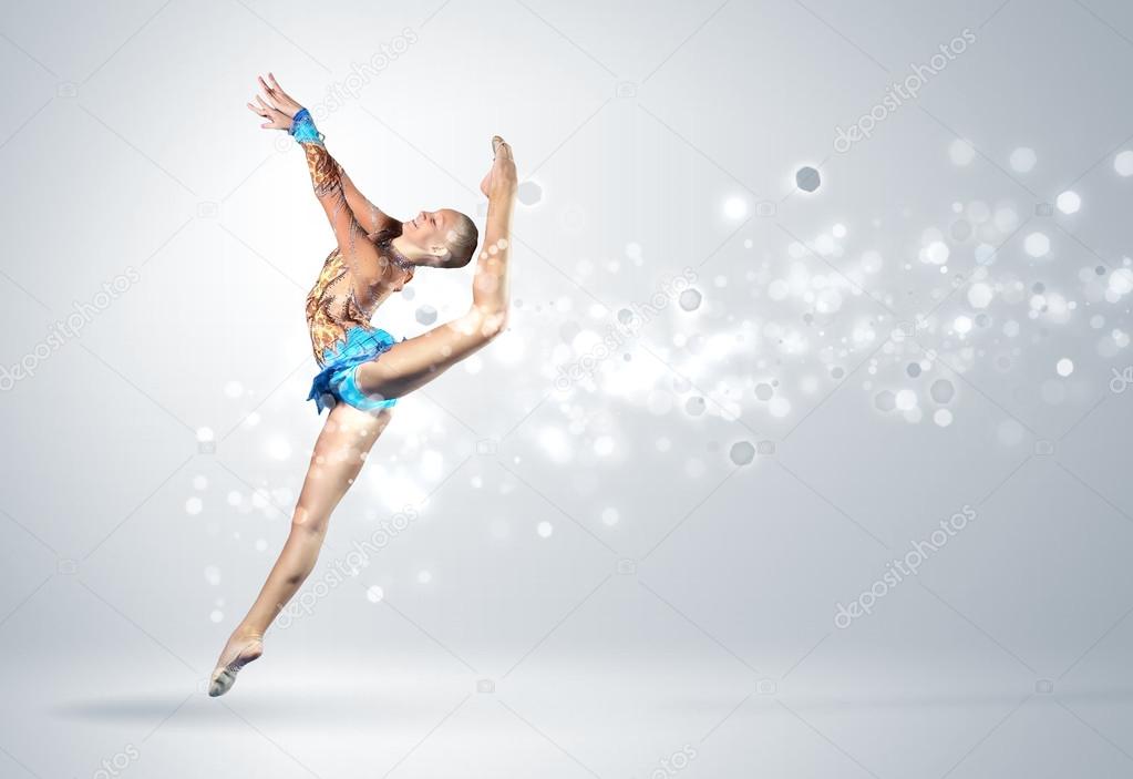 Young woman in gymnast suit posing