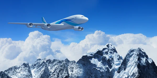 White passenger plane above the mountains — Stock Photo, Image